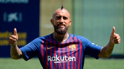 Arturo Vidal poses during his official presentation at the Camp Nou in Barcelona. AFP
