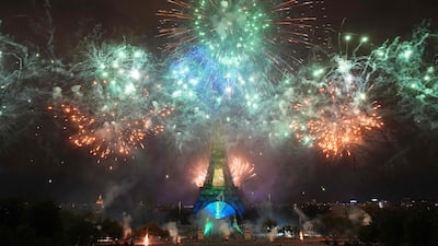 Fireworks light up around the Eiffel Tower during a choreographed firework and drone show to celebrate Bastille Day, in Paris, on July 14, 2025. (Photo by Dimitar DILKOFF / AFP)