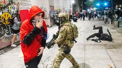 Federal officers disperse Black Lives Matter protesters in Portland. AP