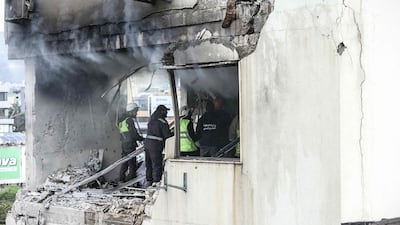 Emergency workers respond after an apartment was hit in Beirut's Burj Hammoud suburb. AFP