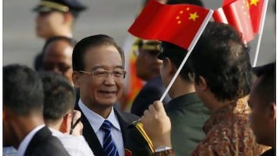 Chinese Premier Wen Jiabao smiles as he arrives for the Association of South East Asian Nations (Asean) Summit in Bali on Thursday. Indonesia is hosting the 19th Asean Summit and a related summit.