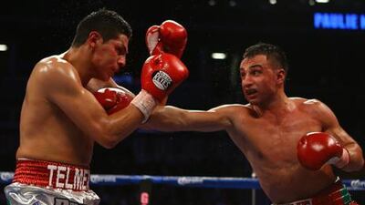Paulie Malignaggi lands a punch through Pablo Cesar Cano's defence during their bout in Brooklyn