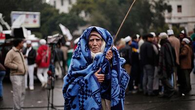 A supporter of the Aam Aadmi Party uses a blanket to protect himself on a cold winter morning at the site of a protest in New Delhi. Adnan Abidi / Reuters
