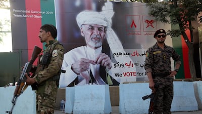 Afghan security forces stand in front of an election poster of president Ashraf Ghani in Kabul, which is at high risk of Taliban attacks during the presidential election on September 28, 2019. AP Photo