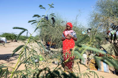 A Sudanese refugee stands in front of her shelter at the Oure Cassoni camp in Chad. AFP