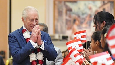 Britain's King Charles III is greeted by children as he arrives to visit the Hindu BAPS Shri Swaminarayan Mandir, better known as Neasden Temple, in London, to celebrate its 30th anniversary. AFP