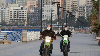 Police members wear face masks as they ride on motorbikes at Beirut's seaside Corniche as Lebanon declared a medical state of emergency. REUTERS
