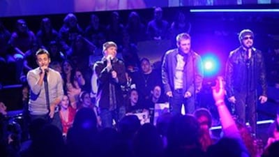 The Backstreet Boys - Howie Dorough, Brian Littrell, Nick Carter, and AJ McLean - performing for MTV in 2008.