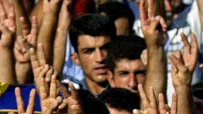 Kurdish demonstrators hold their Turkish identity cards as they demand that they be changed to Kurdish ones.