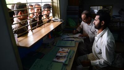 Officials of mortuary of Edhi Welfare Trust, take information from the relatives of missing persons in Karachi. Rampant violence has terrorised Karachi, Pakistan's biggest city and economic heartbeat, in recent years, but a recent security crackdown seems to have brought a lull in the bloodshed. AFP Photo / Asif Hassan
