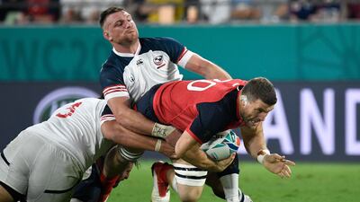 England back row Mark Wilson, right, is tackled by US flanker Tony Lamborn, left. AFP