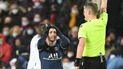 Italian referee Daniele Orsato shows a yellow card to PSG's Marco Verratti. AFP
