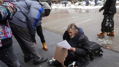 People try and help a homeless man in the Manhattan borough of New York City last week. Reuters
