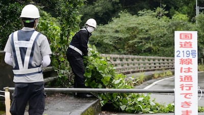 Workers clear debris in Kumamoto, south-western Japan. AP
