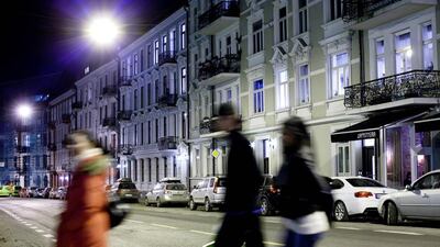 People cross an Oslo street at night-time. Naess’s latest novel in English translation, which is plotted around the disappearance of a 12-year-old girl, is set in the Norwegian capital. Tomm W. Christiansen / Bloomberg