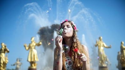A girl blows soap bubbles during a soap bubble festival Dreamflash in Mosco. Alexander Utkin / AFP