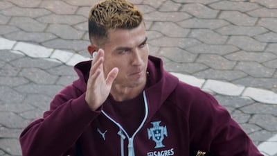 Cristiano Ronaldo waves to fans as he arrives for a training session at Parken Stadium in Copenhagen. AFP