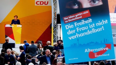 German chancellor Angela Merkel, left, addressed crowds last week, among them the right-wing party Alternative for Germany. The poster reads "Islam is not part of Germany; women's freedom is not negotiable. Michael Probst / AP