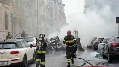 Firefighters attend a fire in a building after a van exploded in central Milan, northern Italy. AP