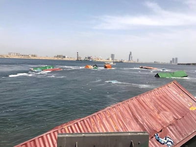 Containers lie in the water in Karachi port after a collision on March 19