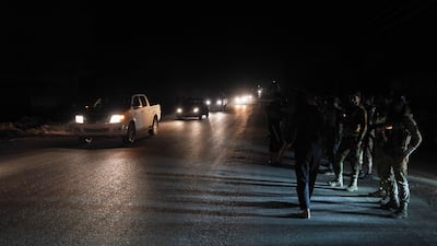 Syrian security forces on patrol in Sweida as vehicles transporting other troops leave. Reuters