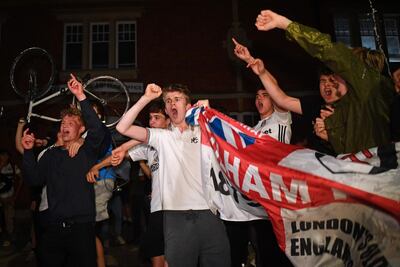 Fulham supporters celebrate outside their team's Craven Cottage football stadium. AFP