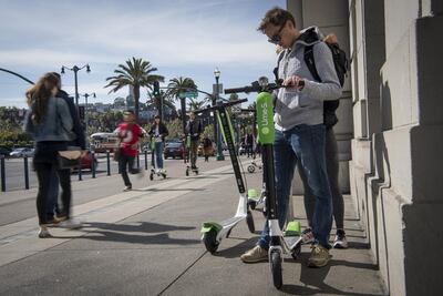 A person uses a smartphone to unlock a LimeBike shared electric scooter in San Francisco, California. David Paul Morris/Bloomberg