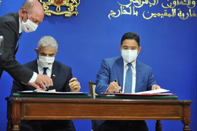Moroccan Foreign Minister Nasser Bourita, right, and his Israeli counterpart Yair Lapid sign co-operation agreements in Rabat, Morocco. EPA