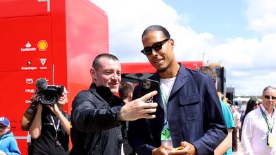 Liverpool's Virgil van Dijk poses for a picture with a fan. Reuters