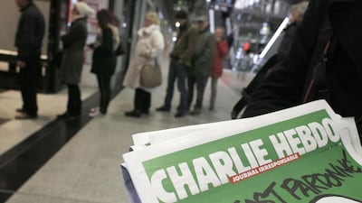 People queue to buy the new issue of Charlie Hebdo newspaper at a newsstand in Paris on January 14, 2015. It was the weekly's first issue since its offices were attacked by extremists who killed 12 people. Christophe Ena / AP Photo