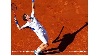 Andy Murray serves during the men's singles first round match to Richard Gasquet of France at the Roland Garros.
