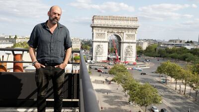 Vladimir Yavachev, a nephew of late artist Christo, who leads the "L'Arc de Triomphe, Wrapped" project poses near at the Arc de Triomphe in Paris, Tuesday, Aug. 24, 2021. The "L'Arc de Triomphe, Wrapped" project by late artist Christo and Jeanne-Claude will be on view for 16 days from, Sept. 18 to Oct. 3, 2021. The famed Paris monument will be wrapped in 25,000 square meters of fabric in silvery blue, and with 3,000 meters of red rope. (AP Photo / Adrienne Surprenant)