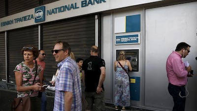 People line up at an ATM in Athens. Greece is on path of economic recovery, IMF says. Reuters