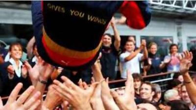 Delighted Toro Rosso mechanics throw their race winning driver Sebastian Vettel into the air.