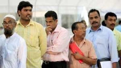 Men wait to vote in the Abu Dhabi Chamber of Commerce and Industry election yesterday.