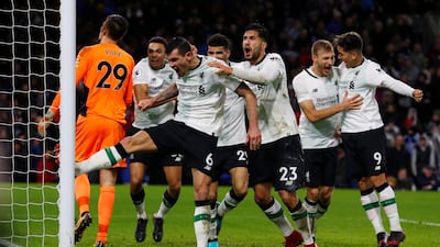 Liverpool players celebrate after Ragnar Klavan's late winning goal against Burnley on Monday. Phil Noble / Reuters