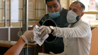 People complete their transactions in the civil status department after Jordan's public sector employees returned gradually to work in Amman. Reuters