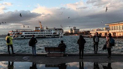 People enjoy their time near Kadikoy ferry station on a windy day in Istanbul, Turkey. EPA