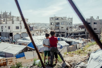 Children observe the destruction in Jabalia camp in northern Gaza. AFP