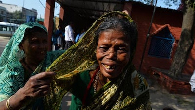 Malsamma, 62, another cured patient, gestures as she shares a light moment with her neighbour.