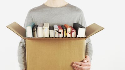 Man Holding Box of Books
