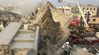 Rescue personnel work on damaged buildings after an earthquake in Tainan, southern Taiwan, on February 6, 2016. Pichi Chuang/Reuters