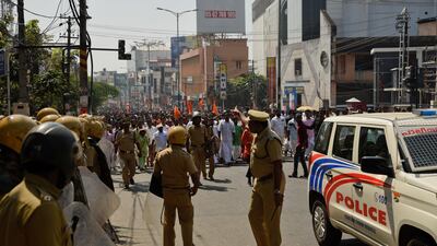 Policemen stand guard during a march by activists from India's ruling BJP party in Thiruvananthapuram, Kerala. AP