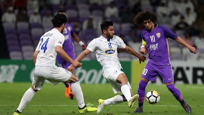 Al Ain captain Omar Abdulrahman, right, in action against Esteghlal on Tuesday. Karim Sahib / AFP
