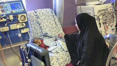Shireen sits with Mayar during her kidney dialysis treatment.