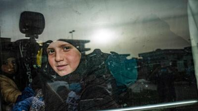 A child sits in a bus during the handover of orphaned children whose parents were suspected of belonging to ISIS to a Russian delegation by Syrian Kurdish officials in Qamishli, north-east Syria. The children, aged between three and 14, were taken into the care of the delegation headed by Anna Kouznetsova, the Russian president's envoy for children's rights. AFP