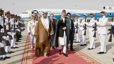 Hamid Karzai is greeted by the UAE Minsiter of Justice Hadef bin Juaan Al Dhaheri on his arrival at Abu Dhabi airport. Philip Cheung / The National