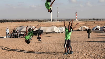 Palestinian youths practice their parkour skills at the Israel-Gaza border in the southern Gaza Strip. Said Khatib / AFP