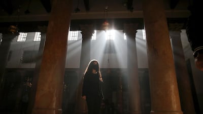 A local tourist visits the Church of Nativity ahead of the Christmas preparations in the West Bank city of Bethlehem. EPA