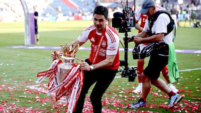 Arsenal manager Mikel Arteta with the Premier League trophy as the team celebrate their first league title in 22 years. EPA